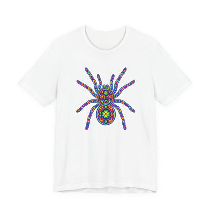 Rainbow tarantula graphic on a white tee, inspired by Mexican Huichol folk art and psychedelic mandalas.