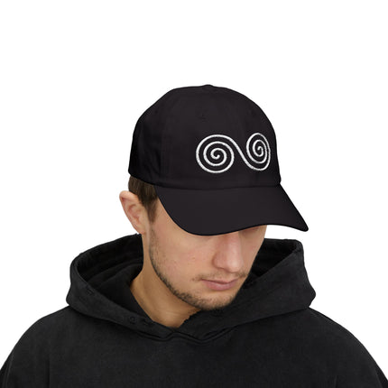Black baseball cap with white embroidered double spiral Celtic symbol.