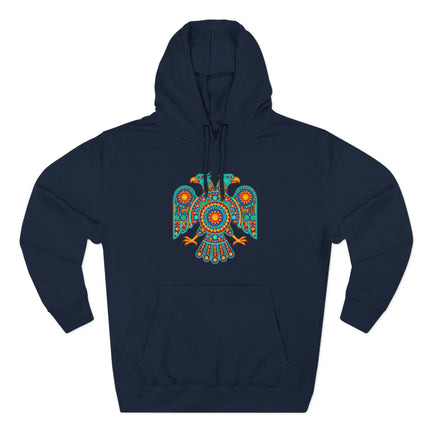 Vibrant Huichol double-headed eagle mandala art graphic on a dark blue pullover hoodie.