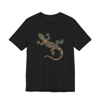 Vibrant Mexican indigenous lizard art print on a black t-shirt, featuring Huichol geometric patterns.