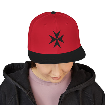 Red snapback cap featuring a black embroidered Maltese Cross symbol.