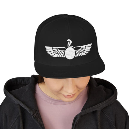 Black snapback hat featuring the Egyptian Uraeus winged cobra symbol.