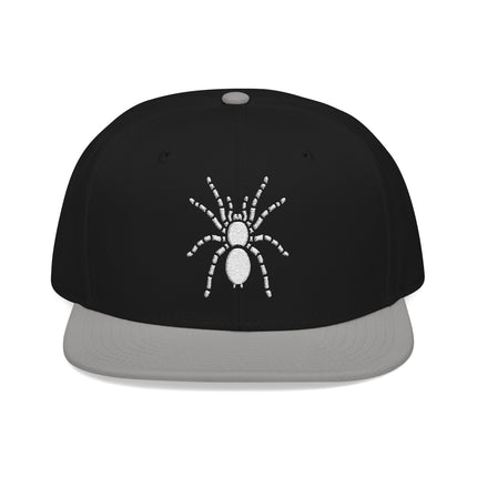 Black snapback cap featuring white embroidered spider graphic.