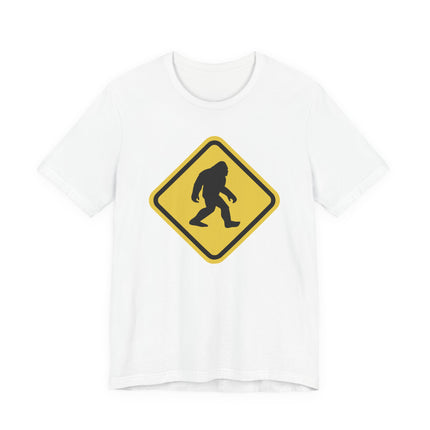 Bigfoot crossing warning sign graphic on a white t-shirt.
