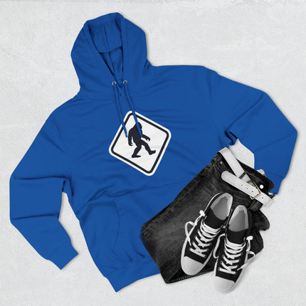 Warning sign graphic of a Bigfoot silhouette crossing on a blue pullover hoodie.