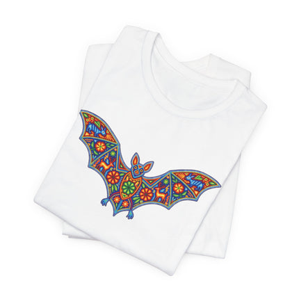 Vibrant Huichol Mexican folk art bat graphic on a white unisex t-shirt.