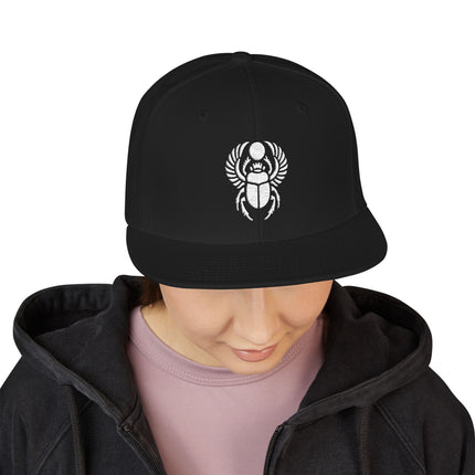 Black snapback cap with embroidered Khepri scarab beetle design, representing ancient Egyptian mythology.