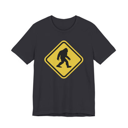Sasquatch crossing warning sign graphic on a black t-shirt.