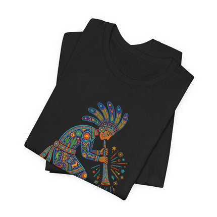 Stylized Kokopelli figure playing a flute on a black t-shirt, tribal folk art design.