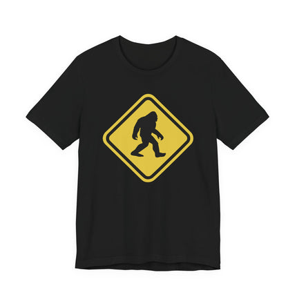Bigfoot crossing warning sign graphic tee for cryptozoology fans.