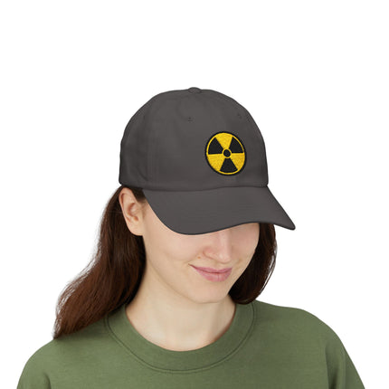 Grey baseball cap with yellow embroidered radioactive warning symbol.