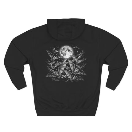 Bats flying around a glowing full moon, gothic celestial print on a black hoodie.