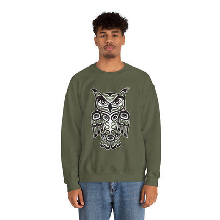 Indigenous Pacific Northwest owl formline art graphic on a green sweatshirt.