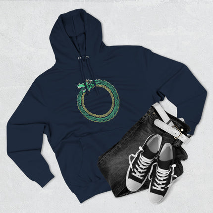 Norse Ouroboros dragon knotwork symbol in green and gold on a dark hoodie.