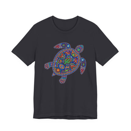 Vibrant Huichol art turtle graphic on a black t-shirt, featuring Mexican indigenous cultural design.