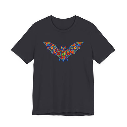 Vibrant Huichol art bat graphic on a black t-shirt, featuring Mexican folk patterns.