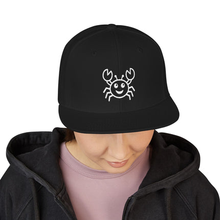 Black snapback cap featuring a cute embroidered smiling crab design.