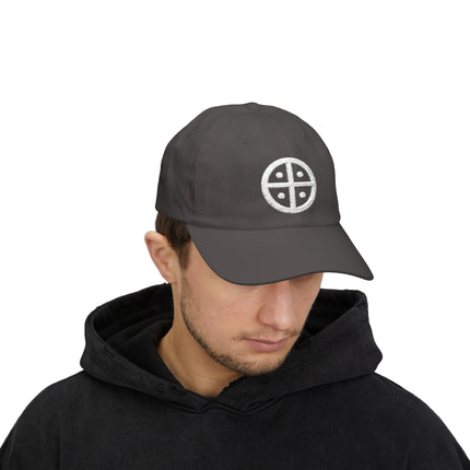 Dark baseball cap with embroidered solar cross sun wheel symbol.