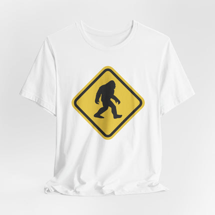 Yellow warning sign graphic featuring a Bigfoot or Sasquatch silhouette crossing.