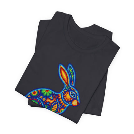 Vibrant Mexican folk art rabbit graphic on a black t-shirt, inspired by Huichol style.