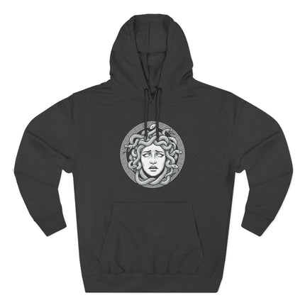 Stylized Medusa Gorgon head graphic with snakes and a Greek key pattern print.