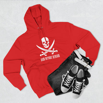 Red hoodie featuring a pirate skull and crossed swords graphic with the text "Rum Before Reason.