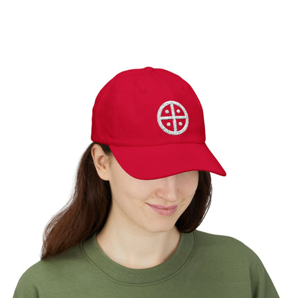 Red baseball cap embroidered with a white solar cross sun wheel symbol.