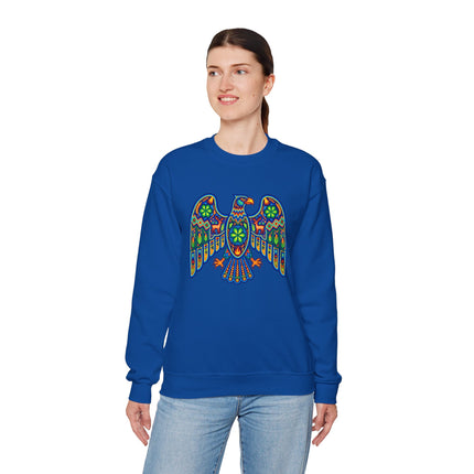 Vibrant Huichol tribal eagle art graphic on a royal blue unisex sweatshirt.