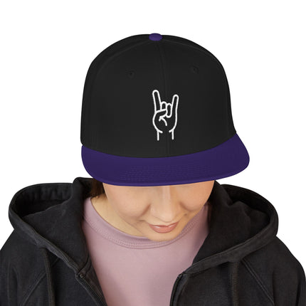 Black snapback cap with purple brim and white embroidered rock hand sign design.