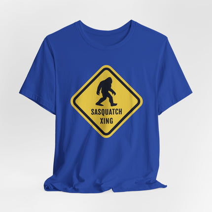 Sasquatch Xing Bigfoot crossing caution sign graphic on a blue t-shirt.
