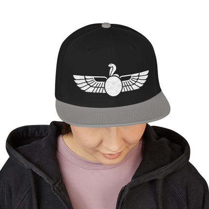 Black snapback hat featuring the Egyptian Uraeus winged cobra symbol.