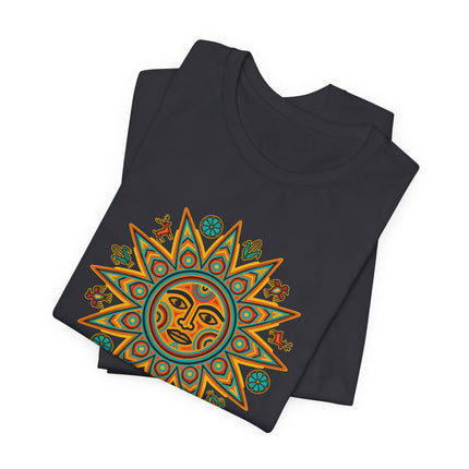 Colorful Huichol Sun Face graphic on a black t-shirt. Indigenous Mexican folk art design featuring vibrant solar symbolism.