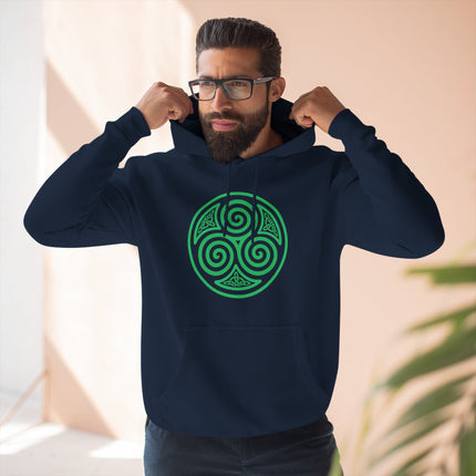 Green Celtic triskelion triple spiral symbol on a navy blue graphic hoodie.