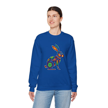 Colorful Huichol beaded rabbit graphic on a royal blue sweatshirt.