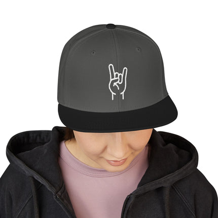 Black snapback cap featuring embroidered rock hand sign (sign of the horns) for streetwear style.