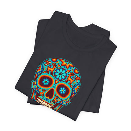 Vibrant Mexican sugar skull (Calavera) graphic tee featuring colorful Huichol folk art for Día de los Muertos.