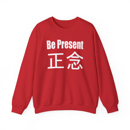 Red sweatshirt featuring "Be Present" and the Japanese kanji 正念, symbolizing mindfulness and Zen living.