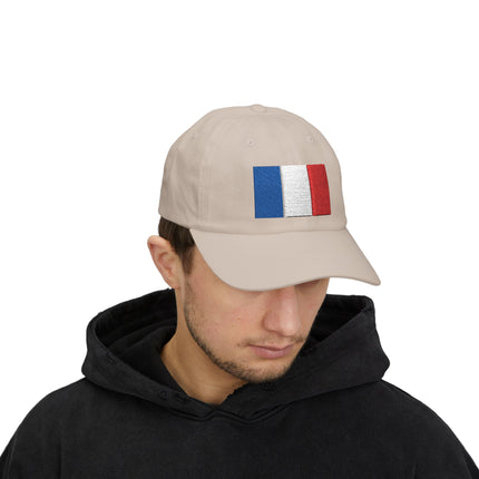 Tan baseball cap featuring the embroidered French tricolor flag. National pride streetwear accessory.