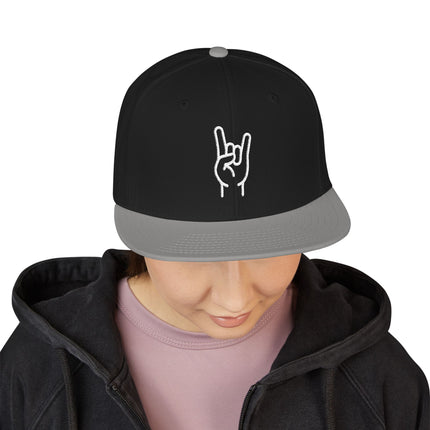 Black snapback cap featuring white embroidered rock hand sign embroidery.