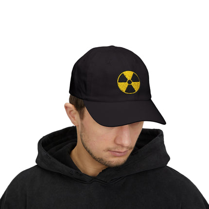Black dad cap featuring a yellow embroidered nuclear hazard symbol.