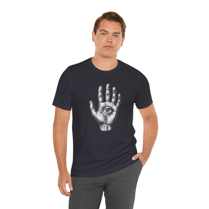 Hand with an eye symbol graphic, a protective Hamsa or Nazar design on a dark t-shirt.