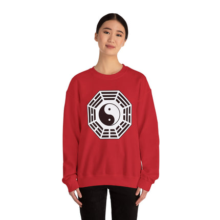 Red sweatshirt featuring a stylized Yin Yang Taijitu symbol graphic representing balance.