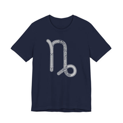 Intricate Capricorn zodiac symbol graphic on a navy blue astrology t-shirt.