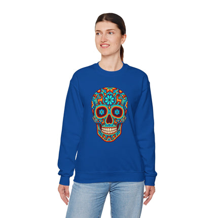 Colorful sugar skull graphic on a blue sweatshirt, featuring Mexican Día de Muertos folk art.