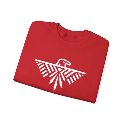 Geometric white eagle graphic on red sweatshirt, representing Thunderbird mythology.