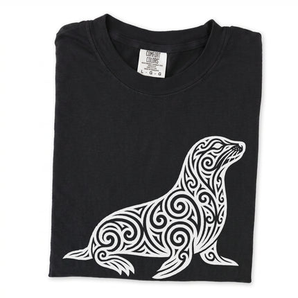 Tribal swirl seal graphic tee featuring ornate marine animal artwork on a comfortable t-shirt.