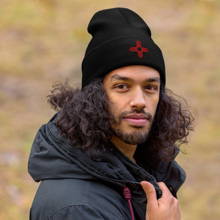 Embroidered Zia Sun beanie with red directional symbol cuff.