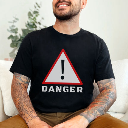Danger warning sign graphic t-shirt featuring bold exclamation mark and hazard symbols.