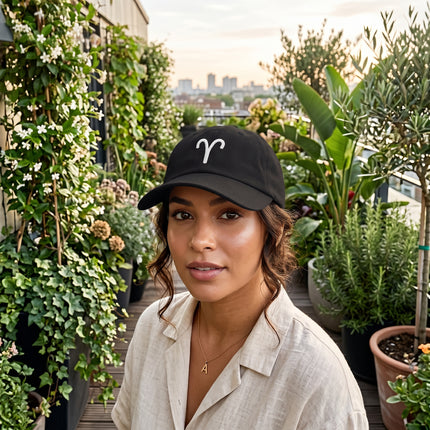 Black dad hat embroidered with the Aries zodiac symbol. Minimalist astrology sign cap.