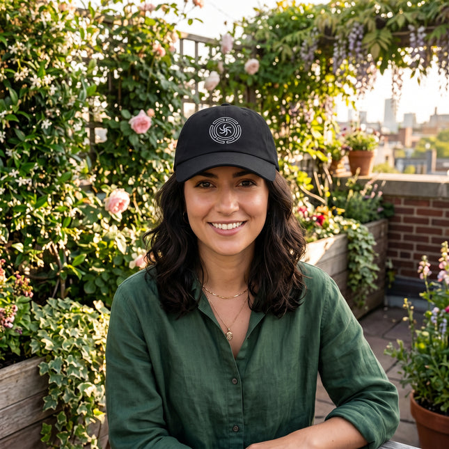 Black baseball cap with embroidered Hekate's Wheel (Strophalos) occult symbol.
